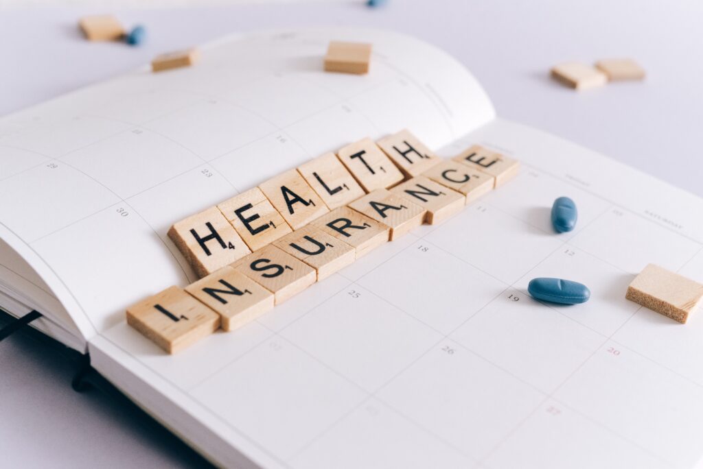 Scrabble tiles spelling the word Health Insurance