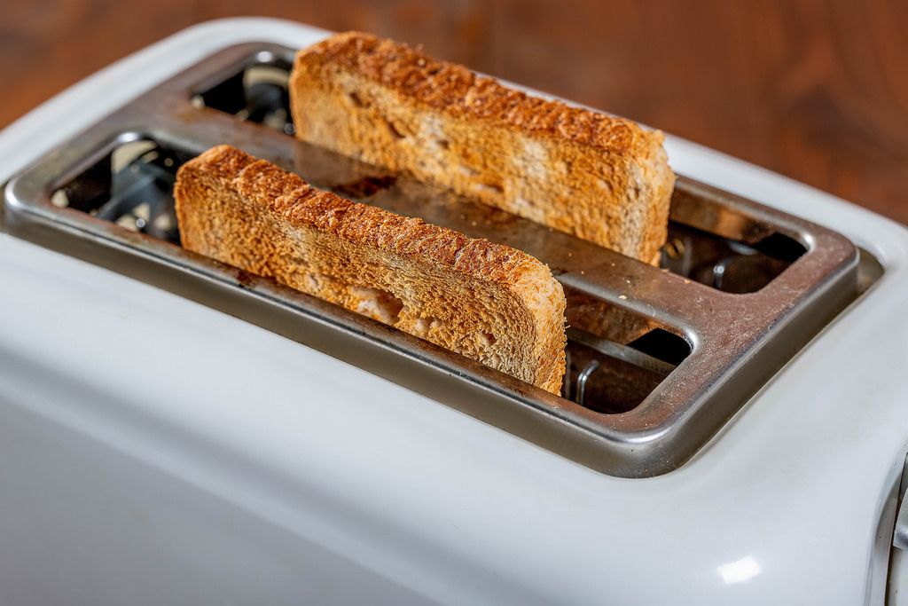 Toasted bread popping up from toaster machine