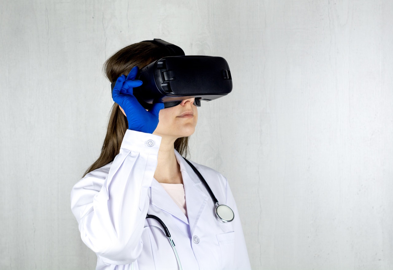 Female doctor wearing VR goggles